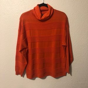 bright orange turtleneck with ruffle stripes